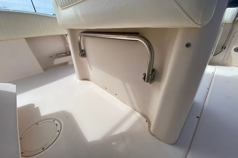 Slide: The Image of 2005 Grady-White Advance 257 boat interior with white seating and stainless steel handle. - 59