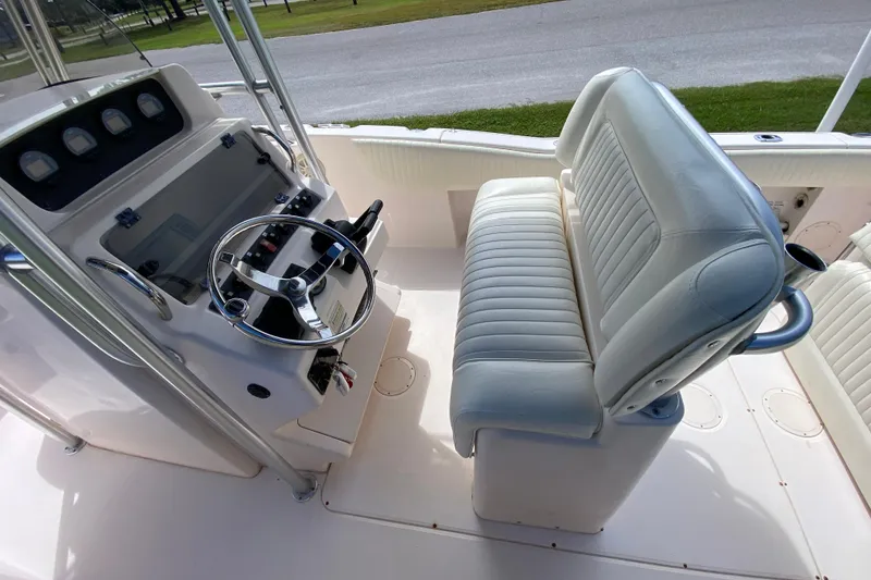 Slide: The Image of 2005 Grady-White Advance 257 boat interior with steering wheel and cushioned seating. - 60