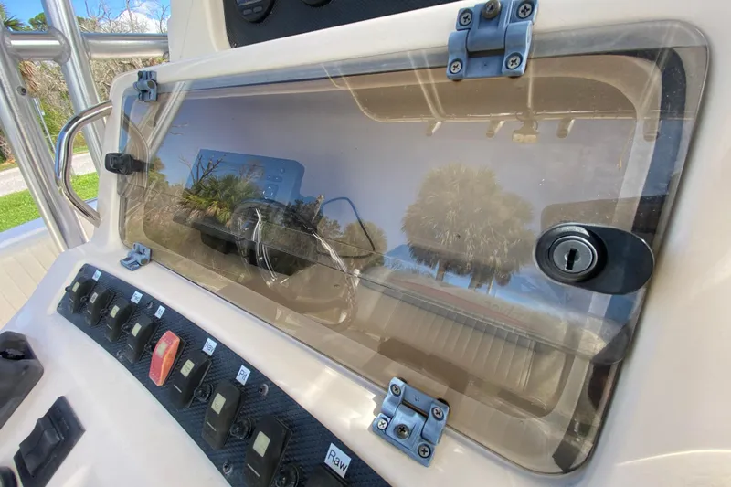 Slide: The Image of 2005 Grady-White Advance 257 boat dashboard with control panel and lockable compartment. - 66