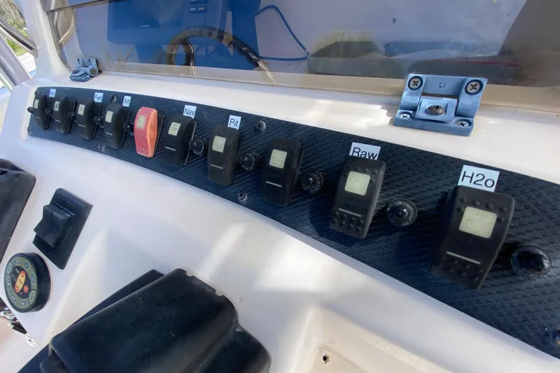 Slide: The Image of Control panel of a 2005 Grady-White Advance 257 boat with labeled switches. - 68