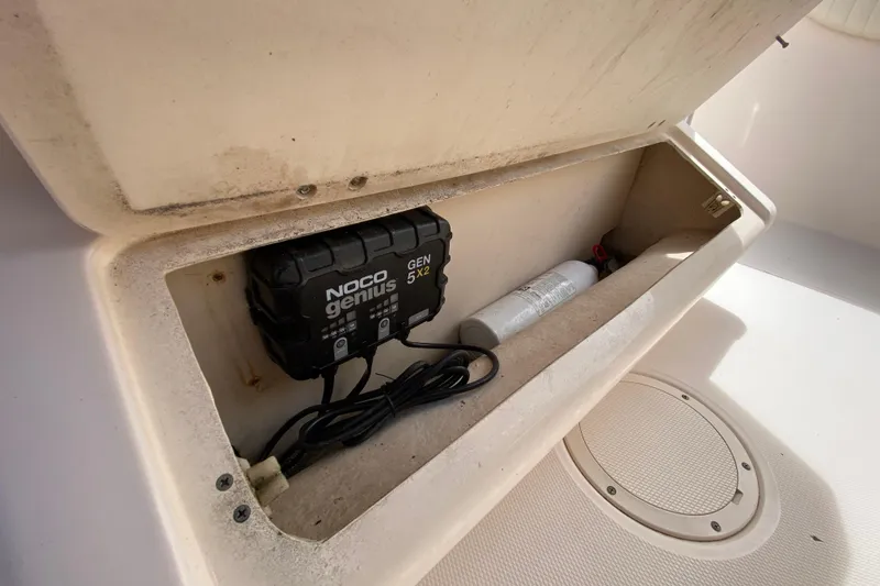 Slide: The Image of Storage compartment in a 2005 Grady-White Advance 257 boat with NOCO Genius charger. - 70
