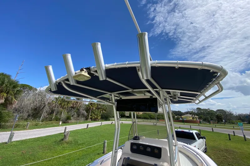 Slide: The Image of 2005 Grady-White Advance 257 boat with T-top, parked on grassy area under blue sky. - 72