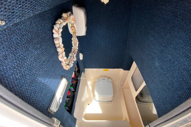Slide: The Image of Interior of 2005 Grady-White Advance 257 boat with marine toilet and shell decoration. - 79