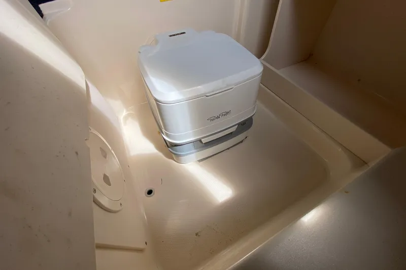 Slide: The Image of Portable toilet in 2005 Grady-White Advance 257 boat interior. - 81