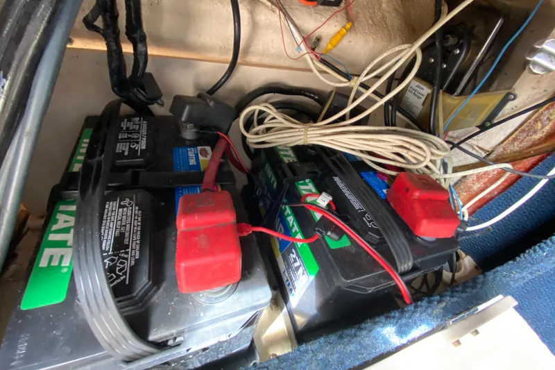 Slide: The Image of Batteries and wiring inside a 2005 Grady-White Advance 257 boat. - 84