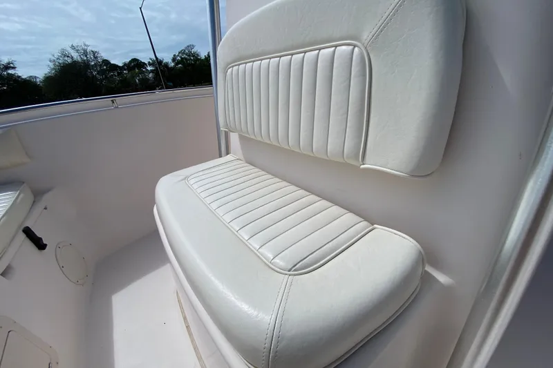 Slide: The Image of 2005 Grady-White Advance 257 boat seat with white cushioned upholstery. - 87
