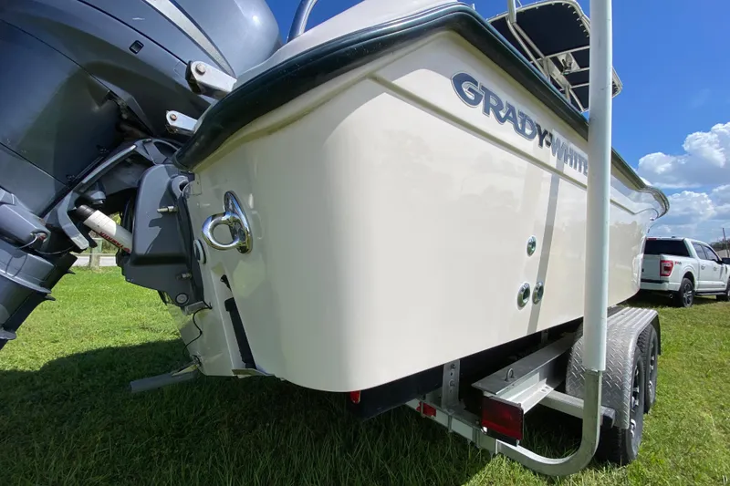 Slide: The Image of 2005 Grady-White Advance 257 boat on trailer, parked on grass under blue sky. - 9