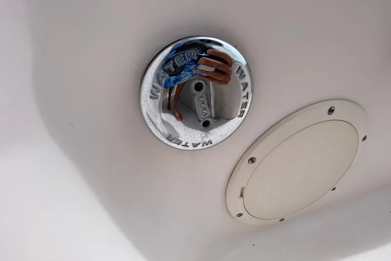 Slide: The Image of 2005 Grady-White Advance 257 boat water inlet and speaker detail. - 92