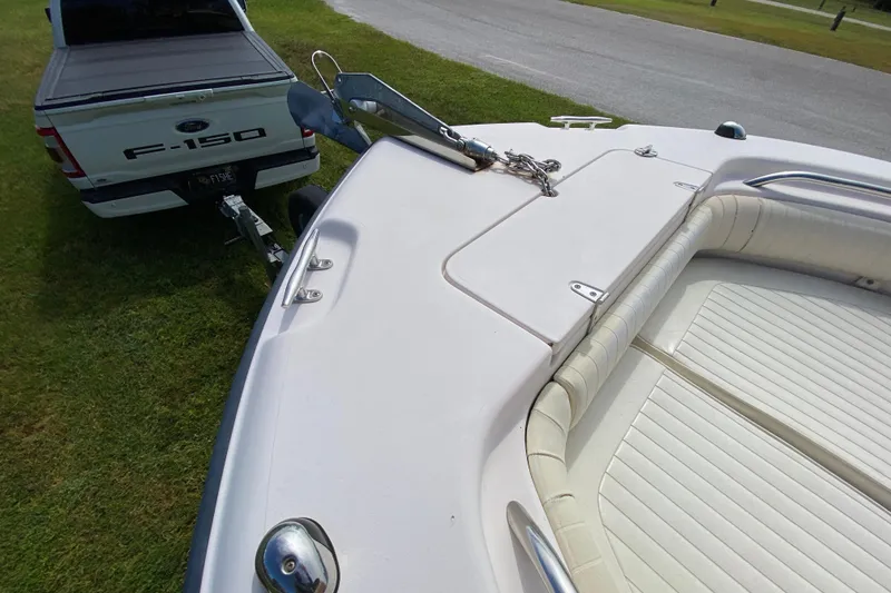 Slide: The Image of 2005 Grady-White Advance 257 boat hitched to Ford F-150 on grass. - 95