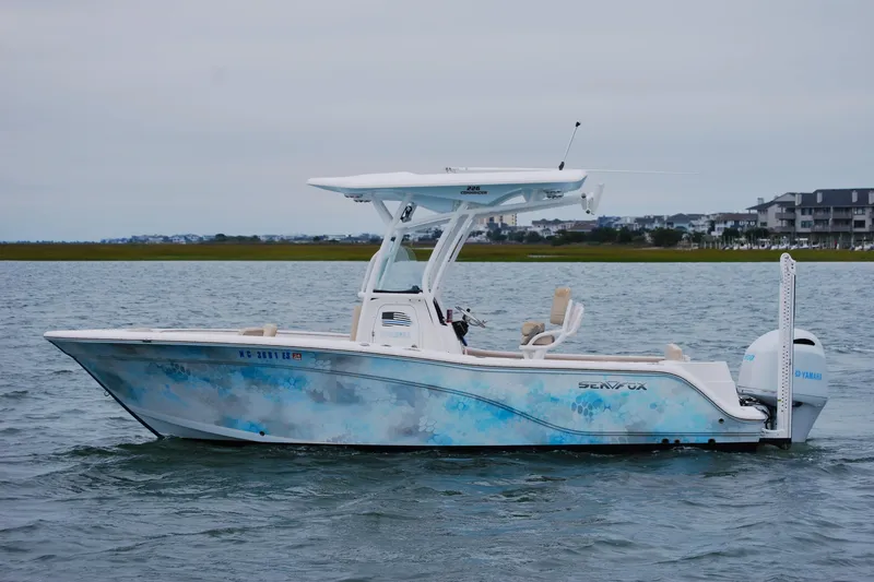 The Image of 2018 Sea Fox 226 Commander boat on water, featuring a sleek design and Yamaha engine. - 0