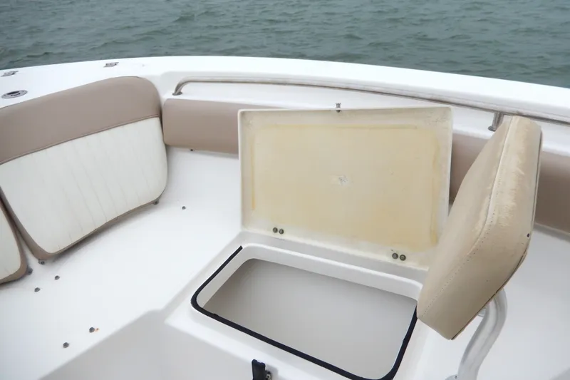 Slide: The Image of 2018 Sea Fox 226 Commander boat with open storage compartment and cushioned seating. - 10