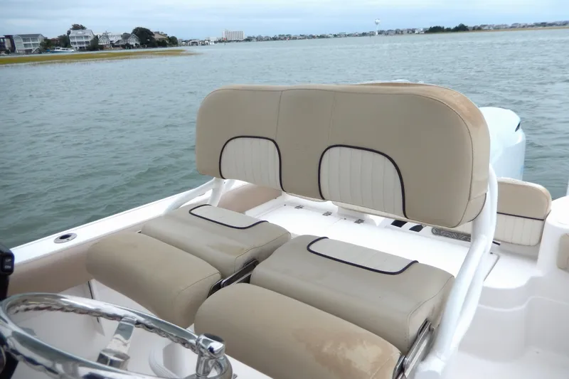 Slide: The Image of 2018 Sea Fox 226 Commander boat storage compartment with white hatch and seating area. - 16