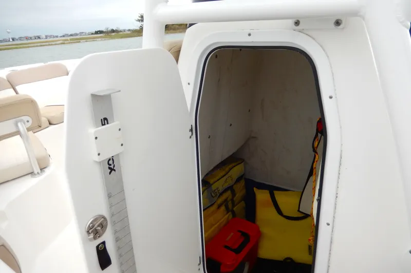 Slide: The Image of Open storage compartment on 2018 Sea Fox 226 Commander boat with blue rope and fender. - 17