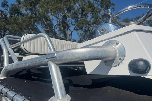 Slide: The Image of 2016 Dargel Kat 250 HDX boat detail with metal railing and seating, outdoors. - 11