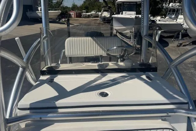 Slide: The Image of 2016 Dargel Kat 250 HDX boat console with windshield and seating in a marina setting. - 13