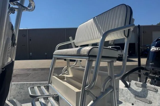 Slide: The Image of 2016 Dargel Kat 250 HDX boat with cushioned seating and storage, parked outdoors. - 8