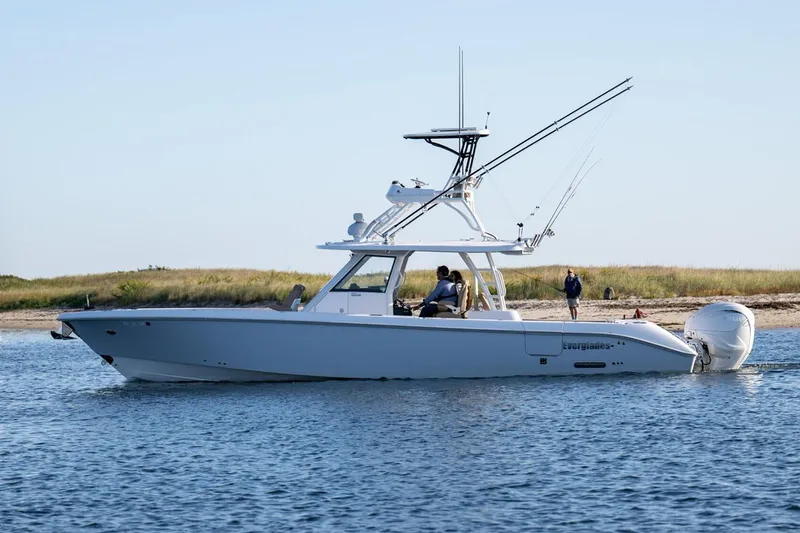 The Image of Manufacturer Provided Image: 2025 Everglades 395 Center Console boat cruising near a sandy shoreline. - 0