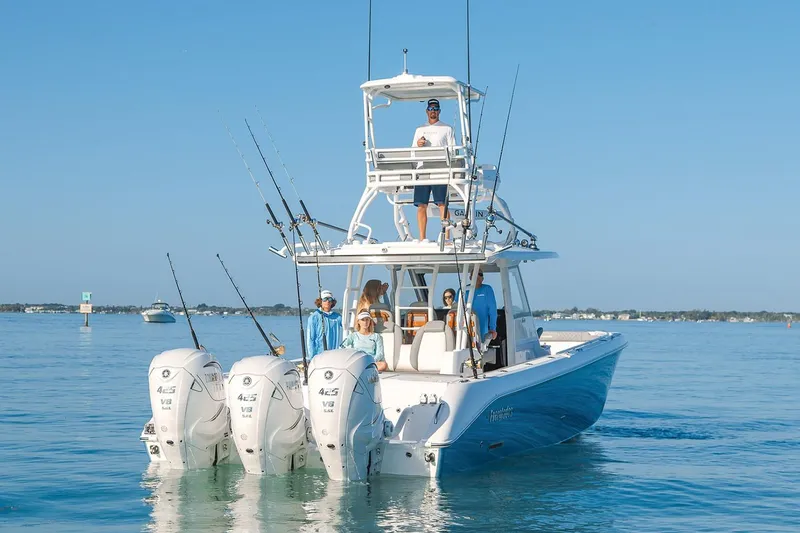 Slide: The Image of Manufacturer Provided Image: 2025 Everglades 395 Center Console boat with triple engines on calm water. - 1