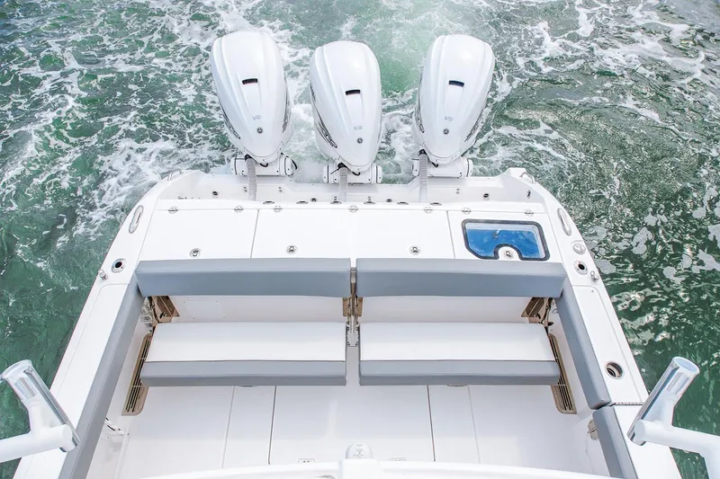 Slide: The Image of Manufacturer Provided Image: 2025 Everglades 395 Center Console boat with triple outboard engines on water. - 8