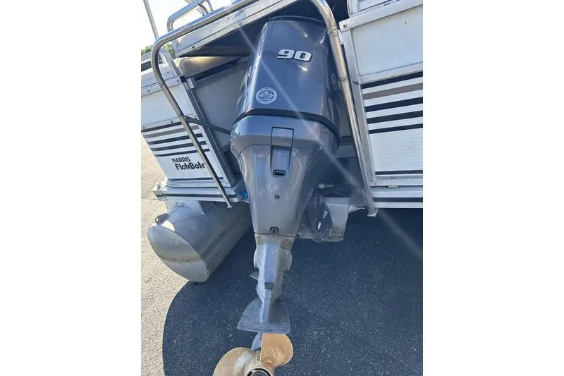 Slide: The Image of 1997 Harris 240 boat with 90 HP outboard motor, rear view. - 11