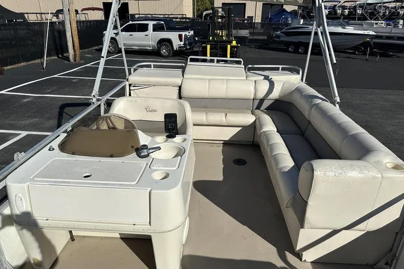 Slide: The Image of 1997 Harris 240 pontoon boat interior with white seating and control console. - 12