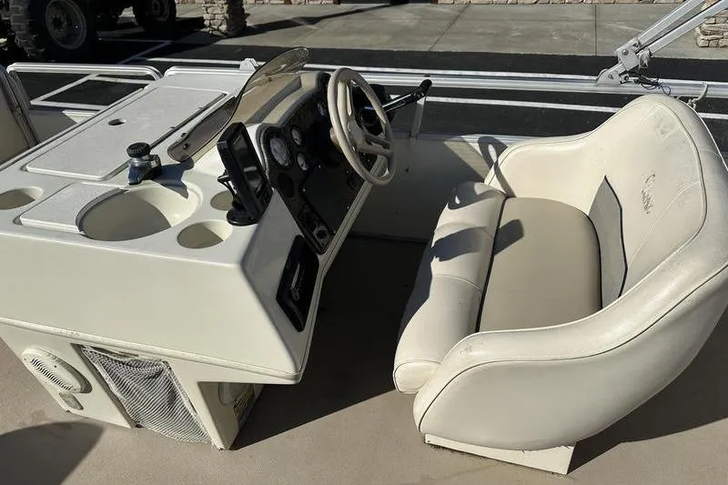 Slide: The Image of 1997 Harris 240 boat interior with steering console and cushioned seating. - 13