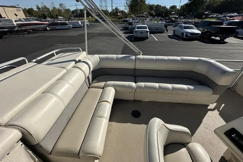 Slide: The Image of 1997 Harris 240 pontoon boat with spacious seating in a parking lot. - 18