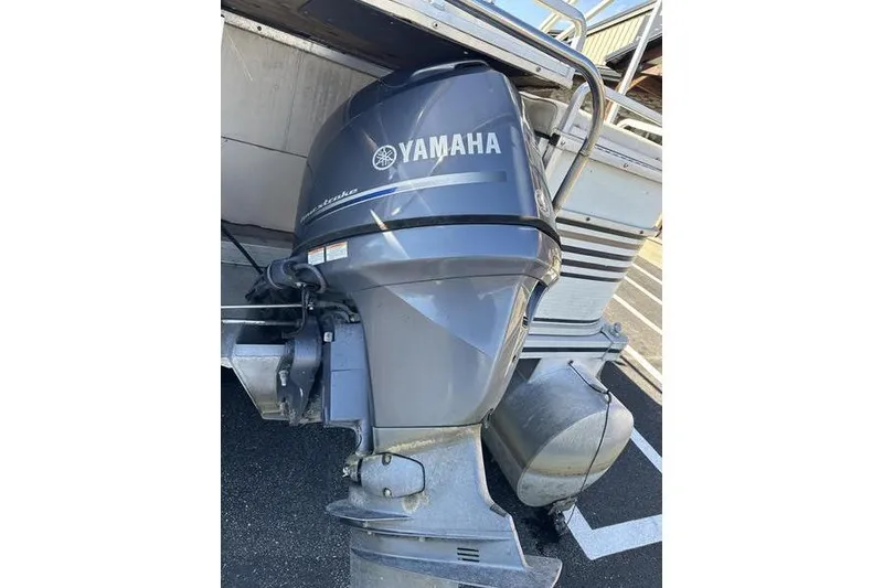 Slide: The Image of Yamaha outboard motor on a 1997 Harris 240 boat, parked in a lot. - 7