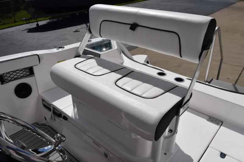 Slide: The Image of 2026 Yamaha Boats 222 FSH Sport E interior with white cushioned seating and steering wheel. - 12