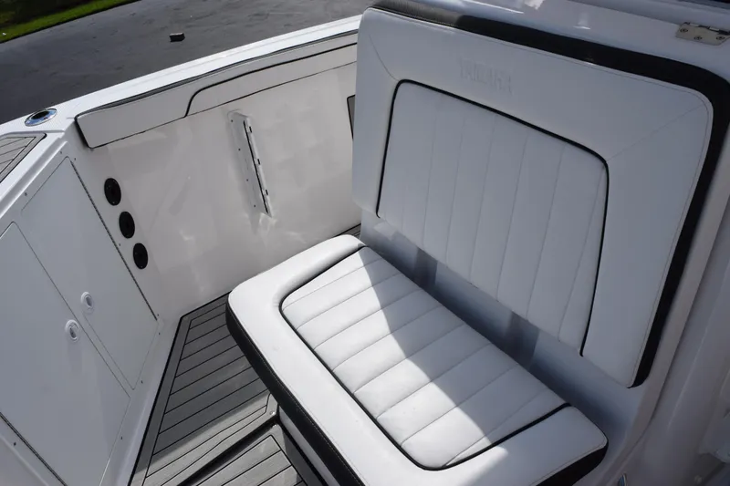 Slide: The Image of 2026 Yamaha Boats 222 FSH Sport E interior seating, featuring sleek white upholstery. - 14