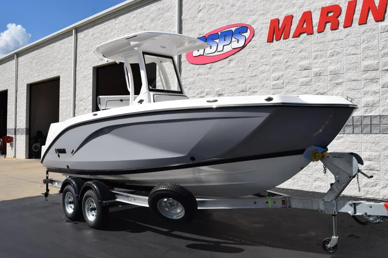 Slide: The Image of 2026 Yamaha Boats 222 FSH Sport E on trailer outside marine dealership. - 2