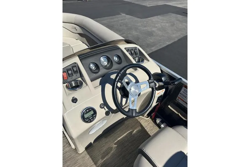 Slide: The Image of 2019 Bennington 22 SSRCX boat dashboard with steering wheel and controls. - 11