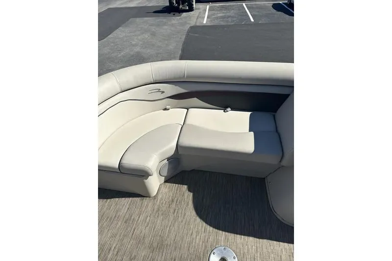 Slide: The Image of 2019 Bennington 22 SSRCX boat interior with beige seating and wood-textured flooring. - 12