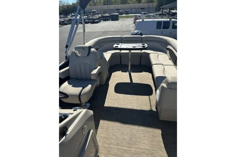 Slide: The Image of 2019 Bennington 22 SSRCX pontoon boat interior with beige seating and table. - 13