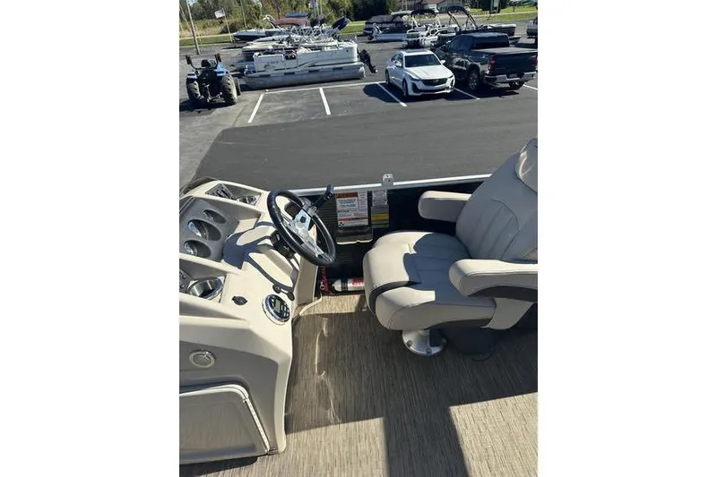 Slide: The Image of 2019 Bennington 22 SSRCX boat interior with steering wheel and captain's chair. - 14