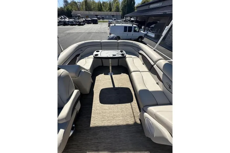 Slide: The Image of 2019 Bennington 22 SSRCX pontoon boat interior with beige seating and table. - 17