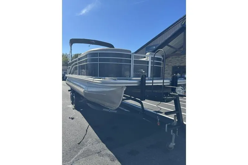 Slide: The Image of 2019 Bennington 22 SSRCX pontoon boat on trailer under clear blue sky. - 3
