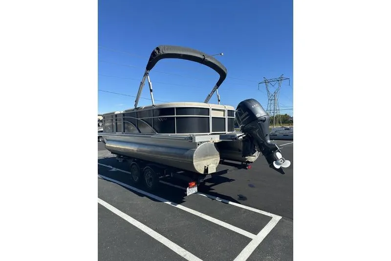 Slide: The Image of 2019 Bennington 22 SSRCX pontoon boat on trailer in parking lot. - 5