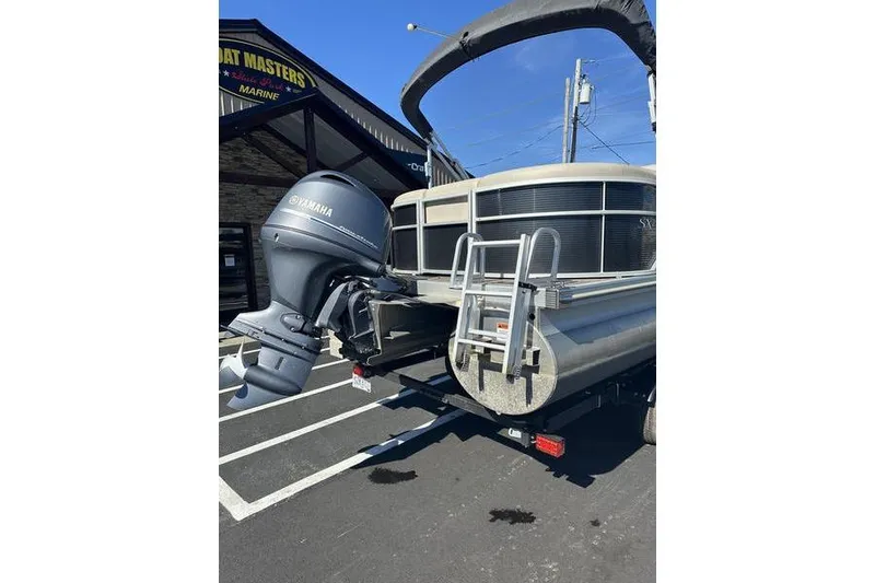 Slide: The Image of 2019 Bennington 22 SSRCX pontoon boat with Yamaha outboard motor in parking lot. - 8
