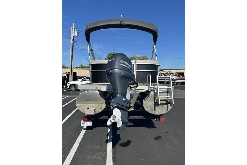 Slide: The Image of 2019 Bennington 22 SSRCX pontoon boat with Yamaha outboard motor, parked in a lot. - 9