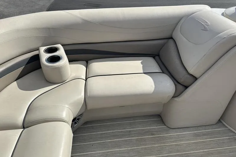 Slide: The Image of 2016 Bennington 2250 GSR boat interior with beige seating and cup holders. - 10