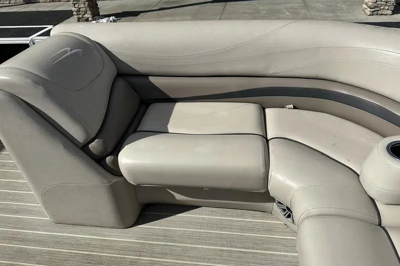 Slide: The Image of Luxurious seating on a 2016 Bennington 2250 GSR pontoon boat, featuring beige upholstery. - 15
