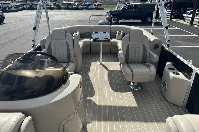 Slide: The Image of 2016 Bennington 2250 GSR pontoon boat interior with beige seating and table. - 16