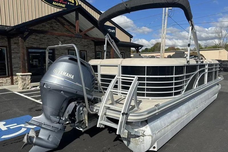 Slide: The Image of 2016 Bennington 2250 GSR pontoon boat with Yamaha outboard motor, parked outside a marine store. - 3