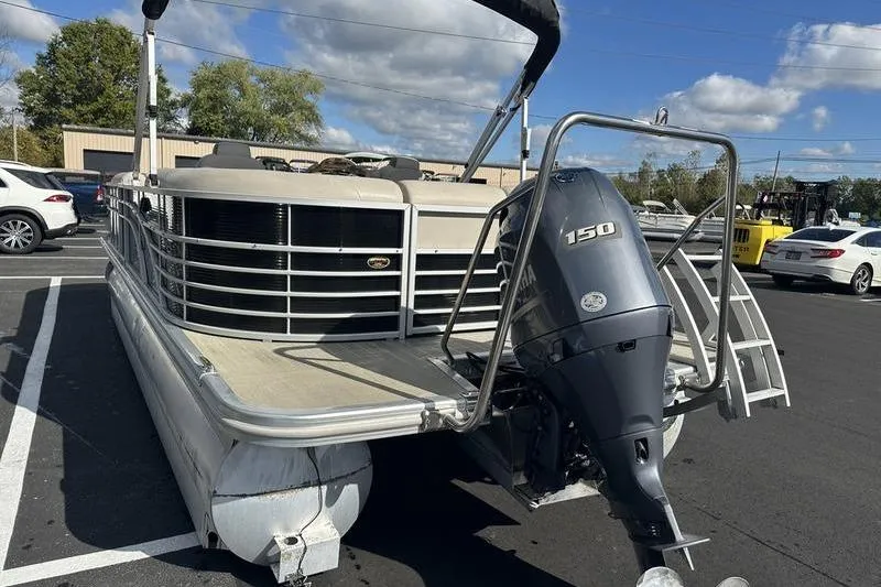 Slide: The Image of 2016 Bennington 2250 GSR pontoon boat with Yamaha 150 outboard motor in parking lot. - 4