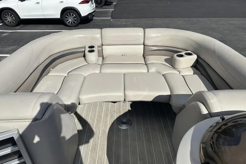 Slide: The Image of 2016 Bennington 2250 GSR boat interior with beige seating and cup holders. - 6