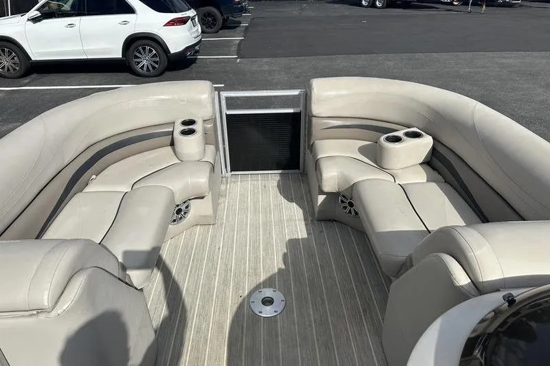 Slide: The Image of 2016 Bennington 2250 GSR pontoon boat interior with beige seating and cup holders. - 7