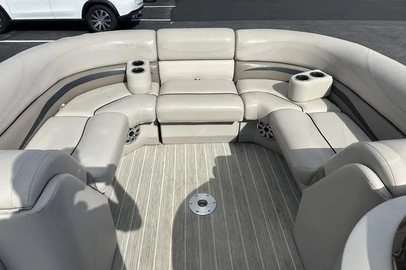 Slide: The Image of 2016 Bennington 2250 GSR boat interior with beige seating and cup holders. - 8