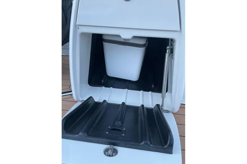 Slide: The Image of 2021 Yamaha Boats 275SD storage compartment with cooler, open view. - 14