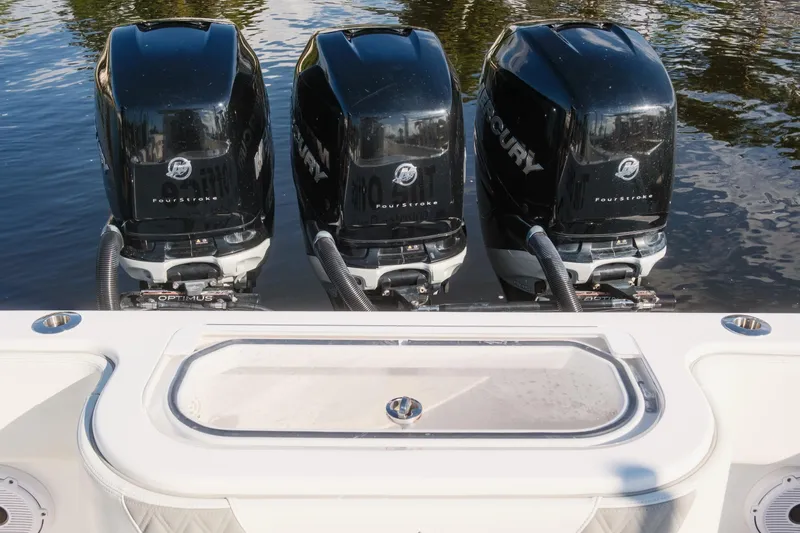 Slide: The Image of 2023 Invincible 36 Open Fisherman boat with luxurious seating, docked by waterfront homes. - 2